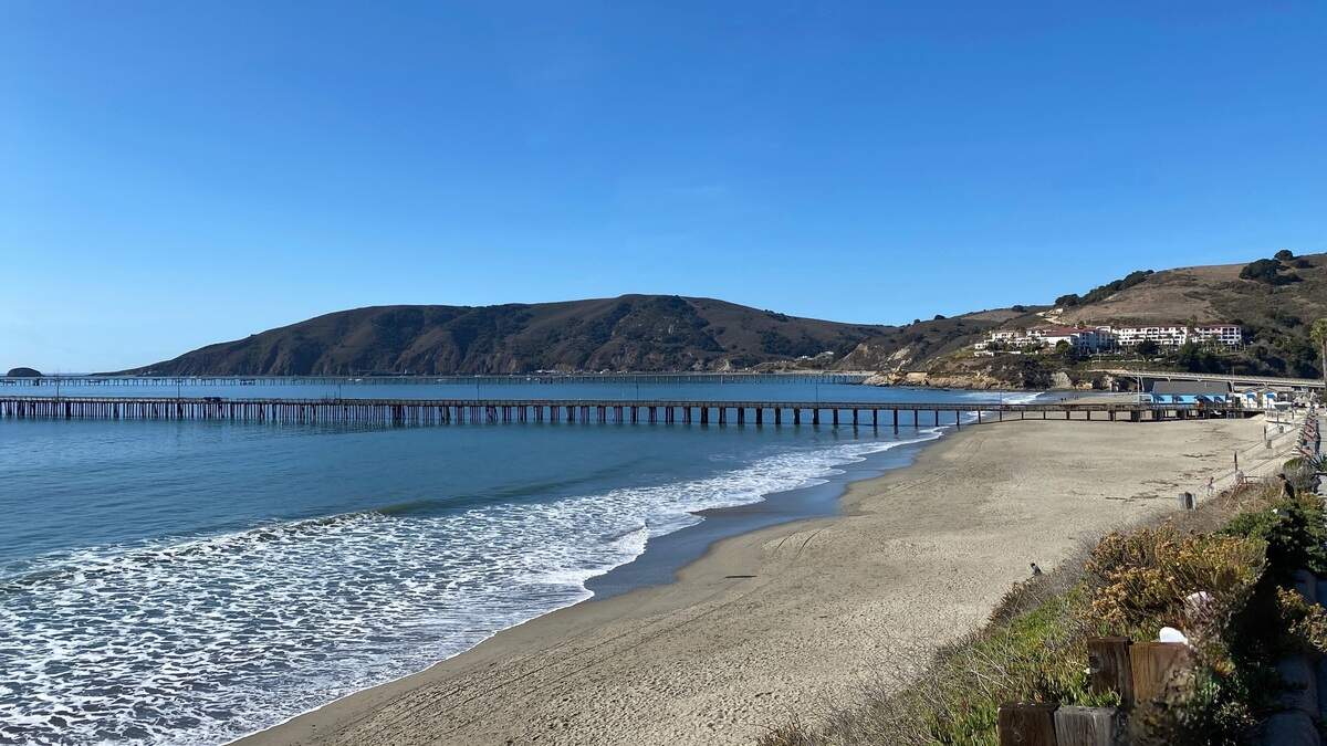 The beach in Avila, California, features a long pier stretching out into the ocean.