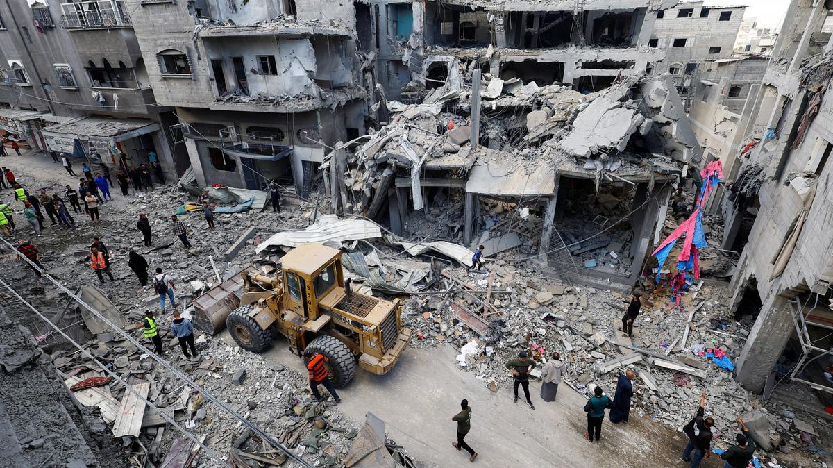 Palestinians gather at the site of an Israeli strike on a house that was pre-warned by the Israeli military to evacuate before the strike was carried out late on Wednesday, in Al-Maghazi refugee camp, in the central Gaza Strip, May 21, 2026. REUTERS/Mahmoud Issa/File Photo