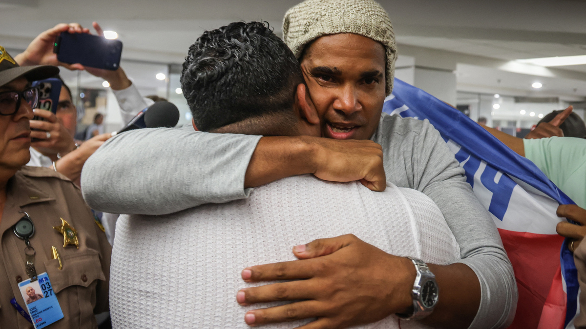 Luis Manuel Otero Alcantara, artist and opponent of the Cuban regime, greets people upon his arrival at Miami International Airport on Saturday, July 18, 2026. (Giorgio Viera/AFP/Getty Images/TNS)
