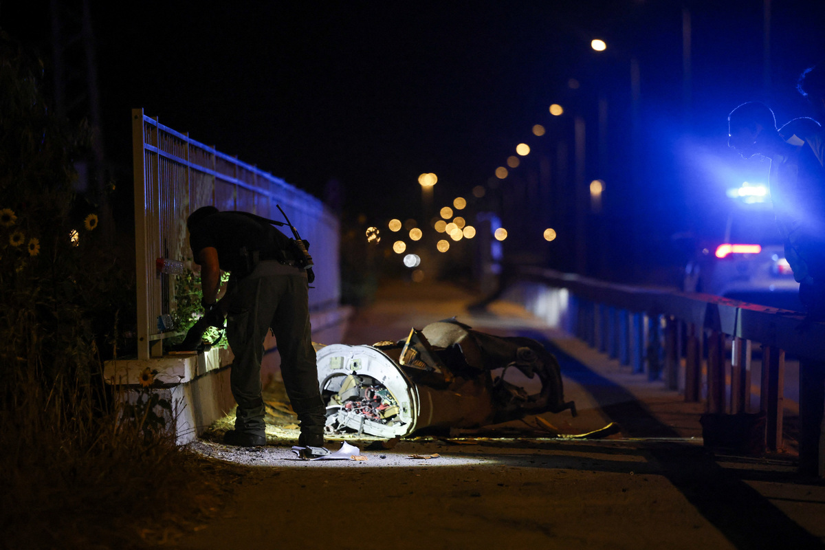 Israeli security works next to a part of a projectile following a missile attack from Iran towards Israel in northern Israel, June 7, 2026. REUTERS/Shir Torem