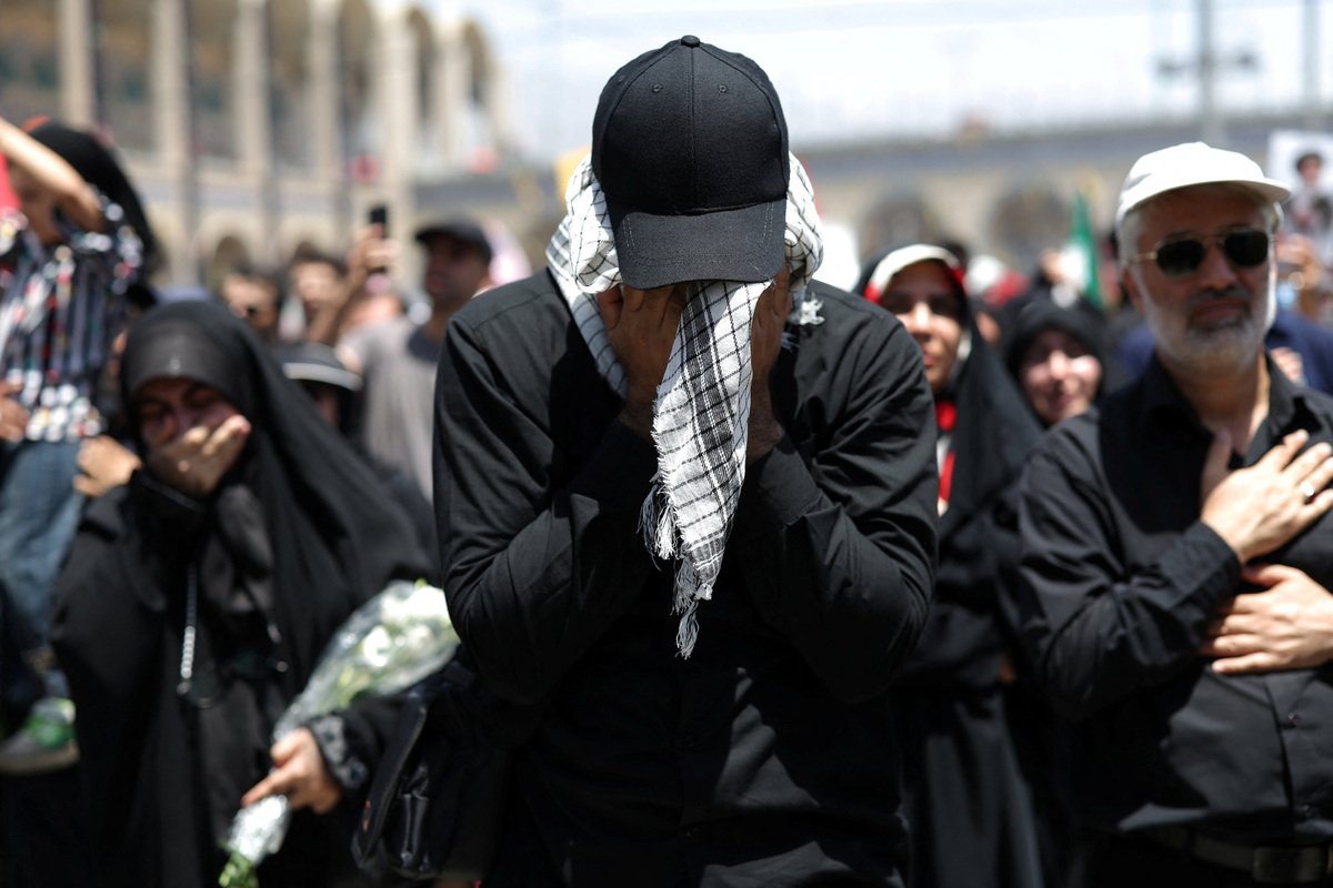 Mourners react as people attend a public farewell ceremony to pay their respects to the late Supreme Leader Ayatollah Ali Khamenei, who was killed on February 28 in Israeli and U.S. airstrikes, at the Imam Khomeini Grand Mosalla, in Tehran, Iran, July 5, 2026. REUTERS/Murad Sezer  Foreign media in Iran operate under guidelines set by the Ministry of Culture and Islamic Guidance, which regulates press activity and permissions