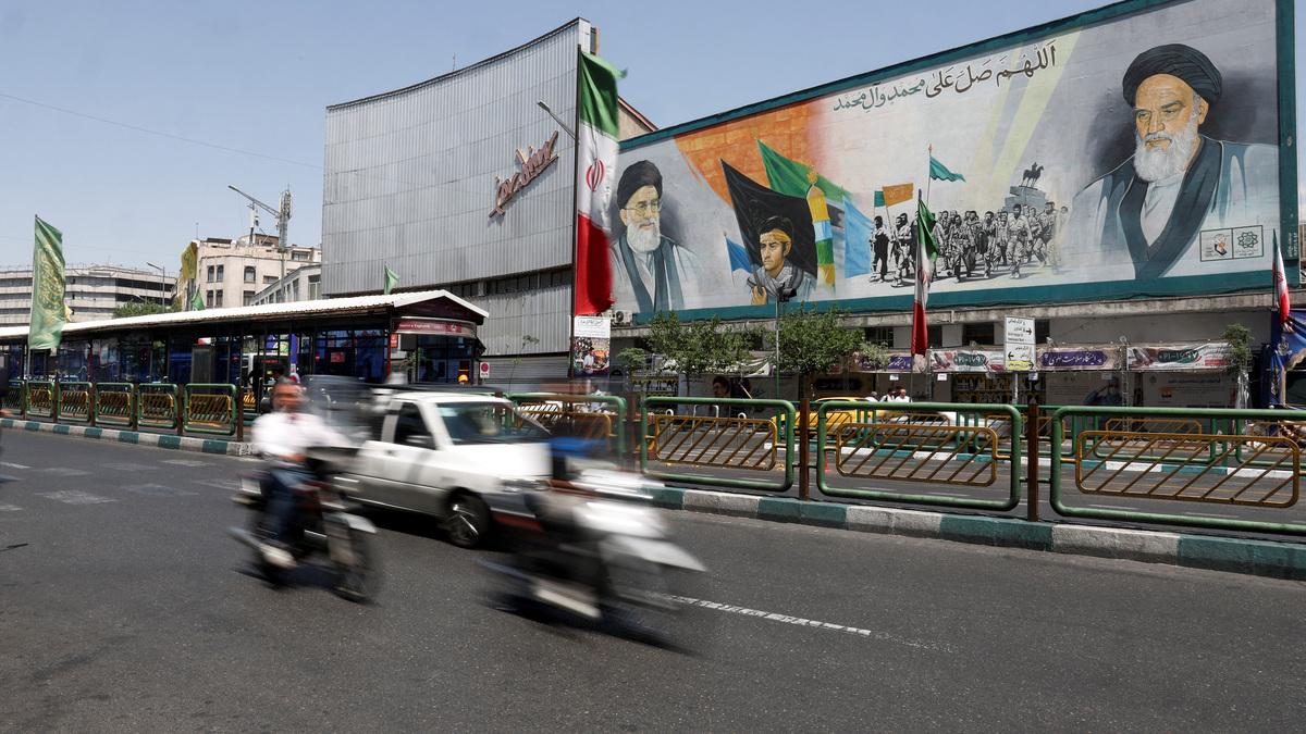 People ride past a mural depicting the late leader of the Islamic Revolution, Ayatollah Ruhollah Khomeini, and the late Iran's Supreme Leader Ayatollah Ali Khamenei, on a street in Tehran, Iran, June 3, 2026. Majid Asgaripour/WANA (West Asia News Agency) via REUTERS/File Photo