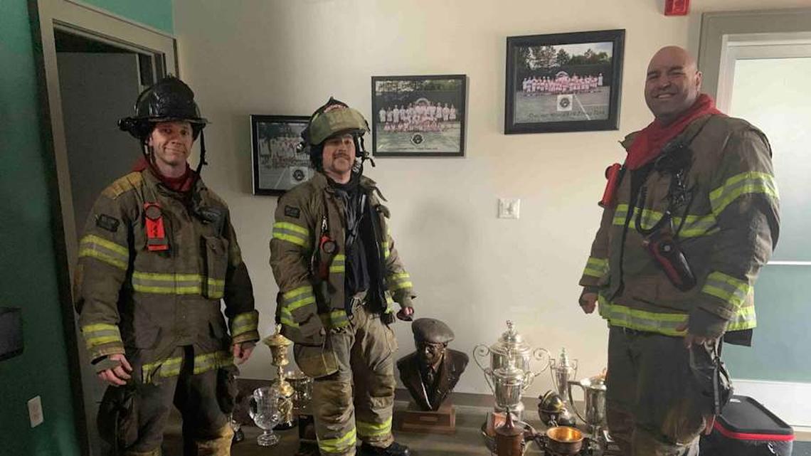  Members of the Southfield Fire Department with some prized trophies saved from the burning clubhouse. | Janina Jacobs 