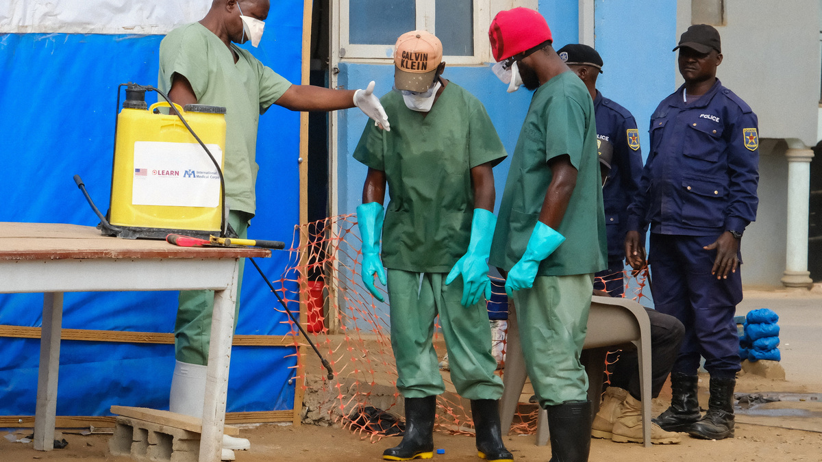 Hygiene teams disinfect the entrance to the Bunia General Reference Hospital before entry, one month after Ebola cases were confirmed in Bunia, eastern Democratic Republic of Congo, on Monday.