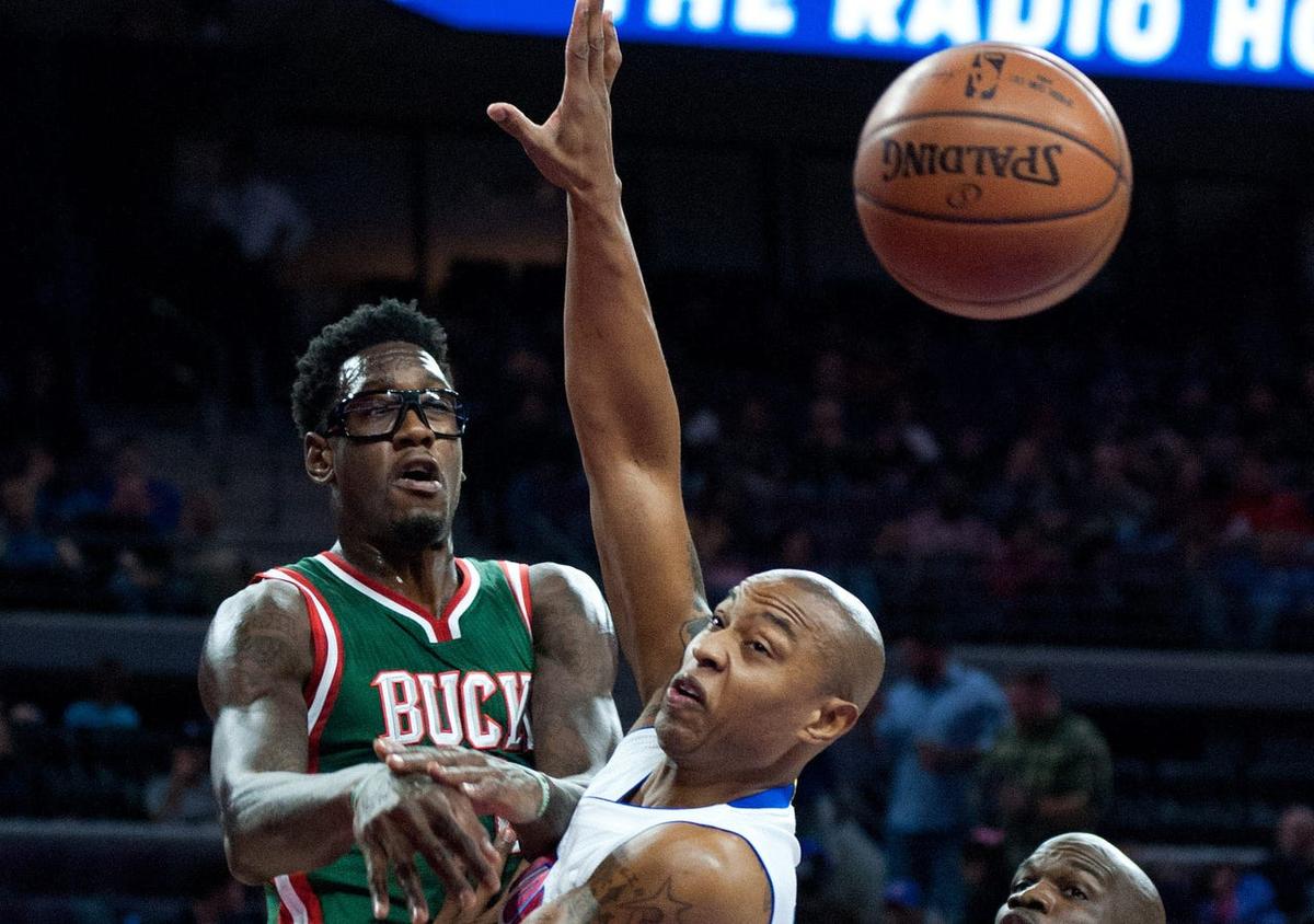 Nov 7, 2014; Auburn Hills, MI, USA; Milwaukee Bucks center Larry Sanders (8) passes the ball around Detroit Pistons forward Caron Butler (31) during the first quarter at The Palace of Auburn Hills. Mandatory Credit: Tim Fuller-USA TODAY Sports
