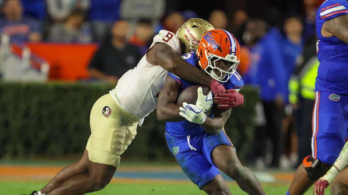  Florida quarterback Harrison Bailey (15) gets tackled by Florida State linebacker Omar Graham Jr. (9) during the second half of an NCAA football game at Steve Spurrier Field at Ben Hill Griffin Stadium in Gainesville, FL on Saturday, November 29, Florida beat Florida State 40-21.2025. [Alan Youngblood/Gainesville Sun] | Alan Youngblood/Gainesville Sun / USA TODAY NETWORK via Imagn Images 
