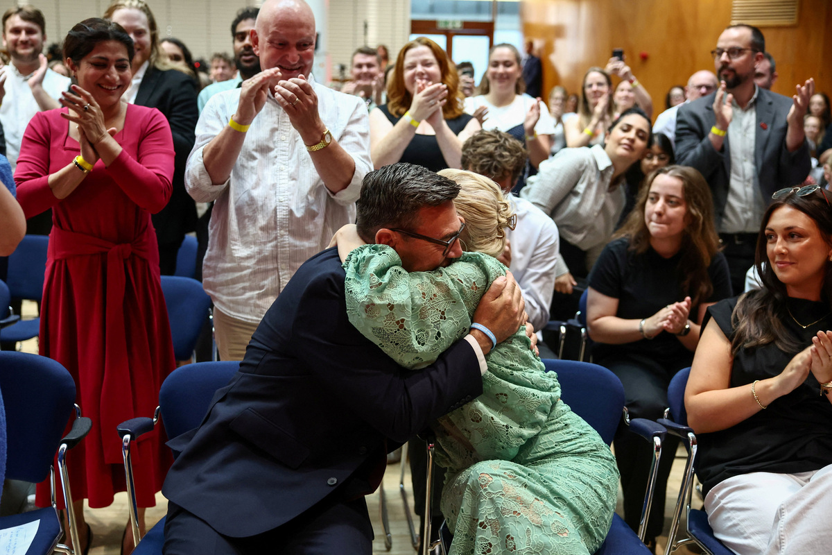 Andy Burnham hugs his wife Marie-France van Heel as he is confirmed as the Labour Party's new leader and the country's next Prime Minister, during 'Labour's Special Conference' in London, Britain, July 17, 2026. HENRY NICHOLLS/Pool via REUTERS