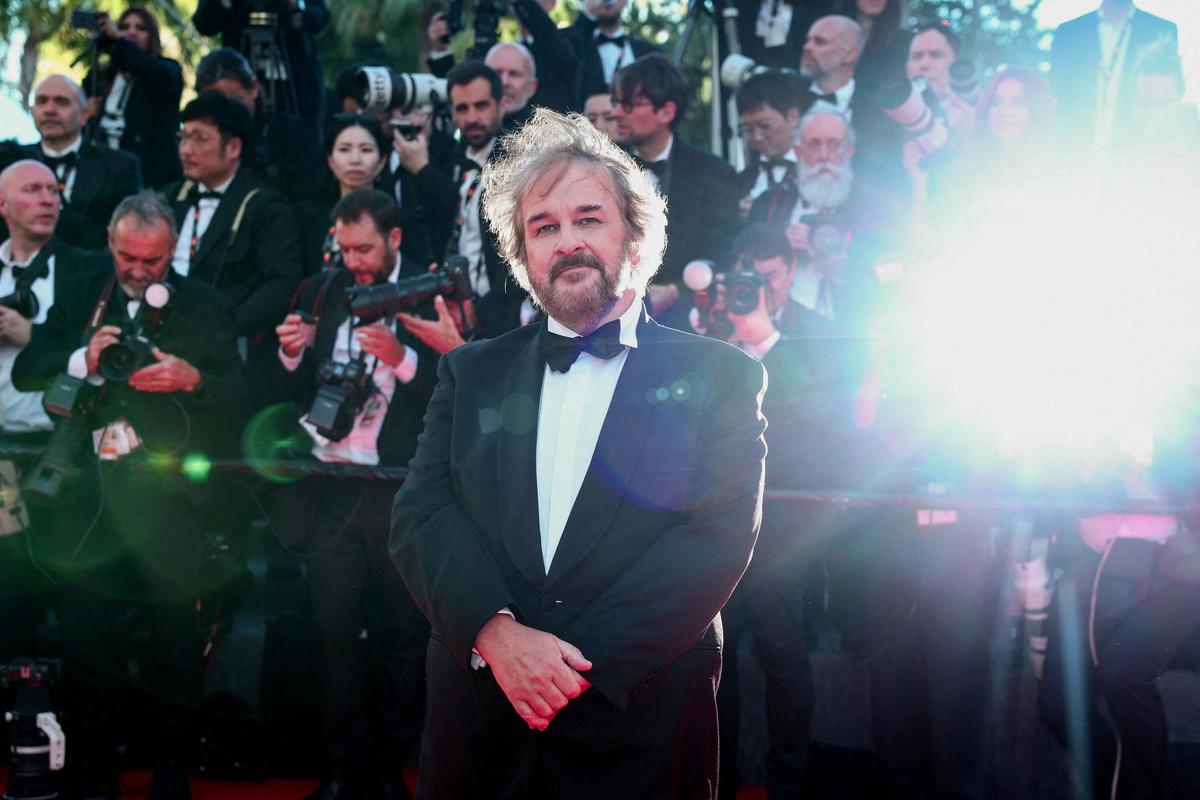 New Zealand filmmaker Peter Jackson, who will be awarded with an Honorary Palme d'Or, poses on the red carpet during arrivals for the opening ceremony and the screening of the film "La Venus electrique" (The Electric Kiss) Out of competition, at the 79th Cannes Film Festival in Cannes, France, May 12, 2026. REUTERS/Gonzalo Fuentes