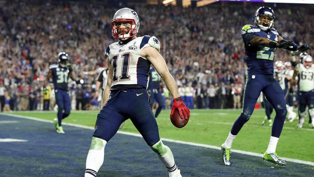  Feb 1, 2015; Glendale, AZ, USA; New England Patriots wide receiver Julian Edelman (11) celebrates scoring a touchdown against Seattle Seahawks cornerback Tharold Simon (27) during the fourth quarter in Super Bowl XLIX at University of Phoenix Stadium. Mandatory Credit: Matthew Emmons-Imagn Images | Matthew Emmons-Imagn Images 