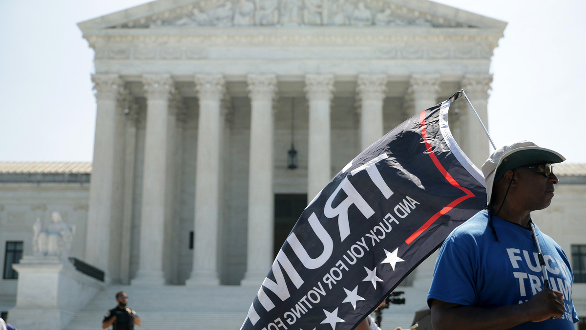 A man carries a flag in front of the U.S. Supreme Court on June 30, 2026, in Washington, D.C. (Alex Wong/Getty Images/TNS)