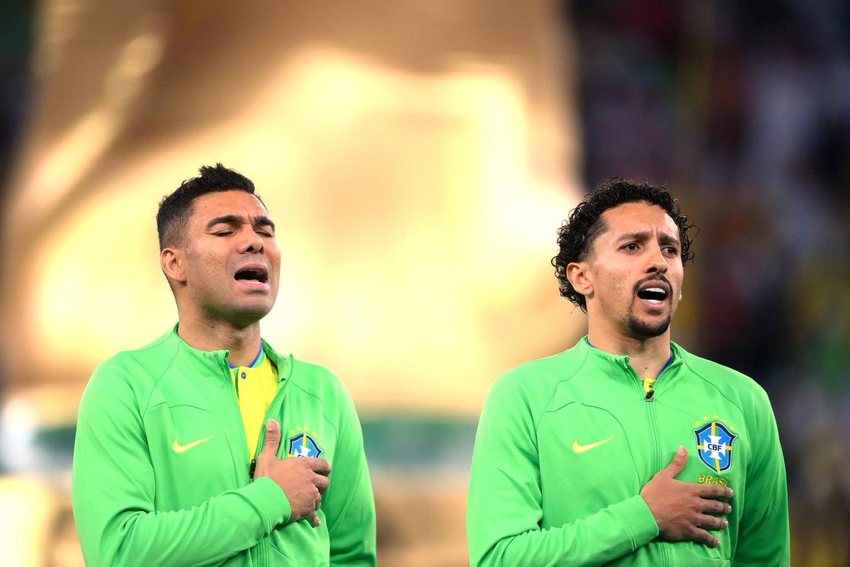  Casemiro and Marquinhos of Brazil sing their national anthem prior to the FIFA World Cup Qatar 2022 quarter final match between Croatia and Brazil at Education City Stadium on December 09, 2022 in Al Rayyan, Qatar. (Photo by Laurence Griffiths/Getty Images) Photo by Laurence Griffiths/Getty Images