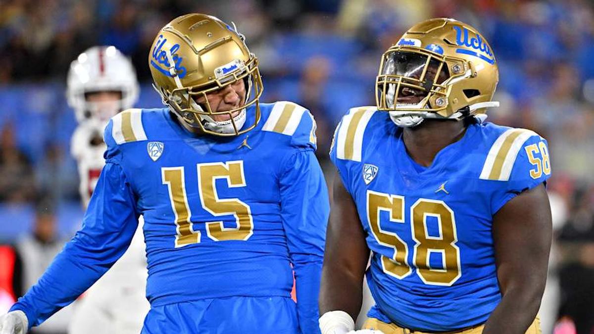  Oct 29, 2022; Pasadena, California, USA; UCLA Bruins linebacker Laiatu Latu (15) and defensive lineman Gary Smith III (58) celebrate after a sack of Stanford Cardinal quarterback Tanner McKee (18) in the first half at the Rose Bowl. Mandatory Credit: Jayne Kamin-Oncea-Imagn Images | Jayne Kamin-Oncea-Imagn Images 