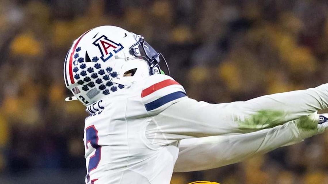 Nov 28, 2025; Tempe, Arizona, USA; Arizona Wildcats defensive back Treydan Stukes (2) intercepts the ball against Arizona State Sun Devils wide receiver Jaren Hamilton (16) in the second half during the 99th Territorial Cup at Mountain America Stadium. Mandatory Credit: Mark J. Rebilas-Imagn Images | Mark J. Rebilas-Imagn Images 