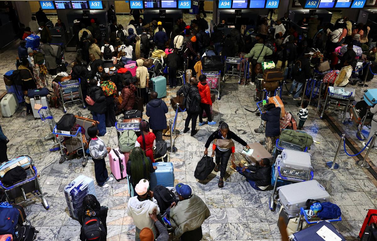 Passengers wait to be checked in as Ghana repatriates hundreds of its citizens from South Africa following instances of violence against migrants from other sub-Saharan African countries, amid a wave of protests against illegal immigration, at O.R. Tambo International Airport in Kempton Park, South Africa, May 27, 2026. REUTERS/Siphiwe Sibeko