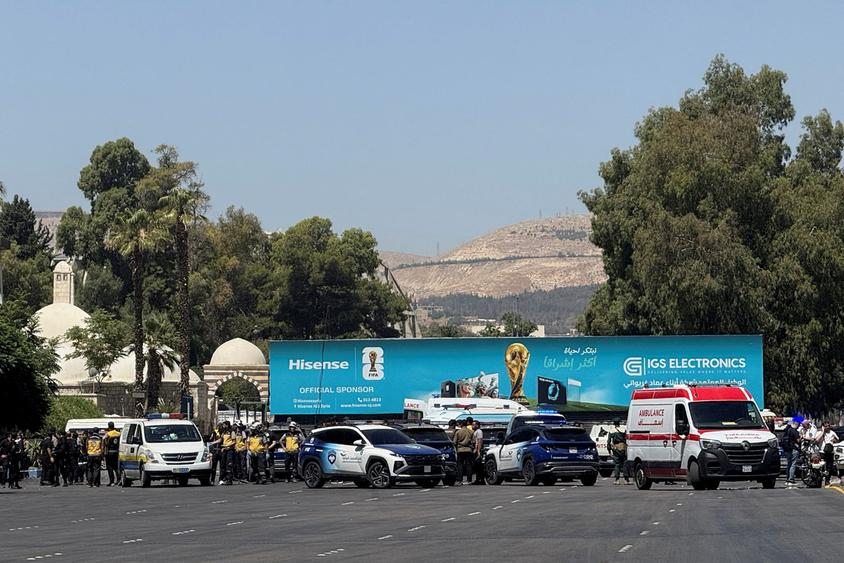Emergency vehicles and personnel at the site where explosive devices blew up near a hotel where French President Emmanuel Macron was meant to be staying, in Damascus, Syria, July 7, 2026. REUTERS/Yamam Al Shaar
