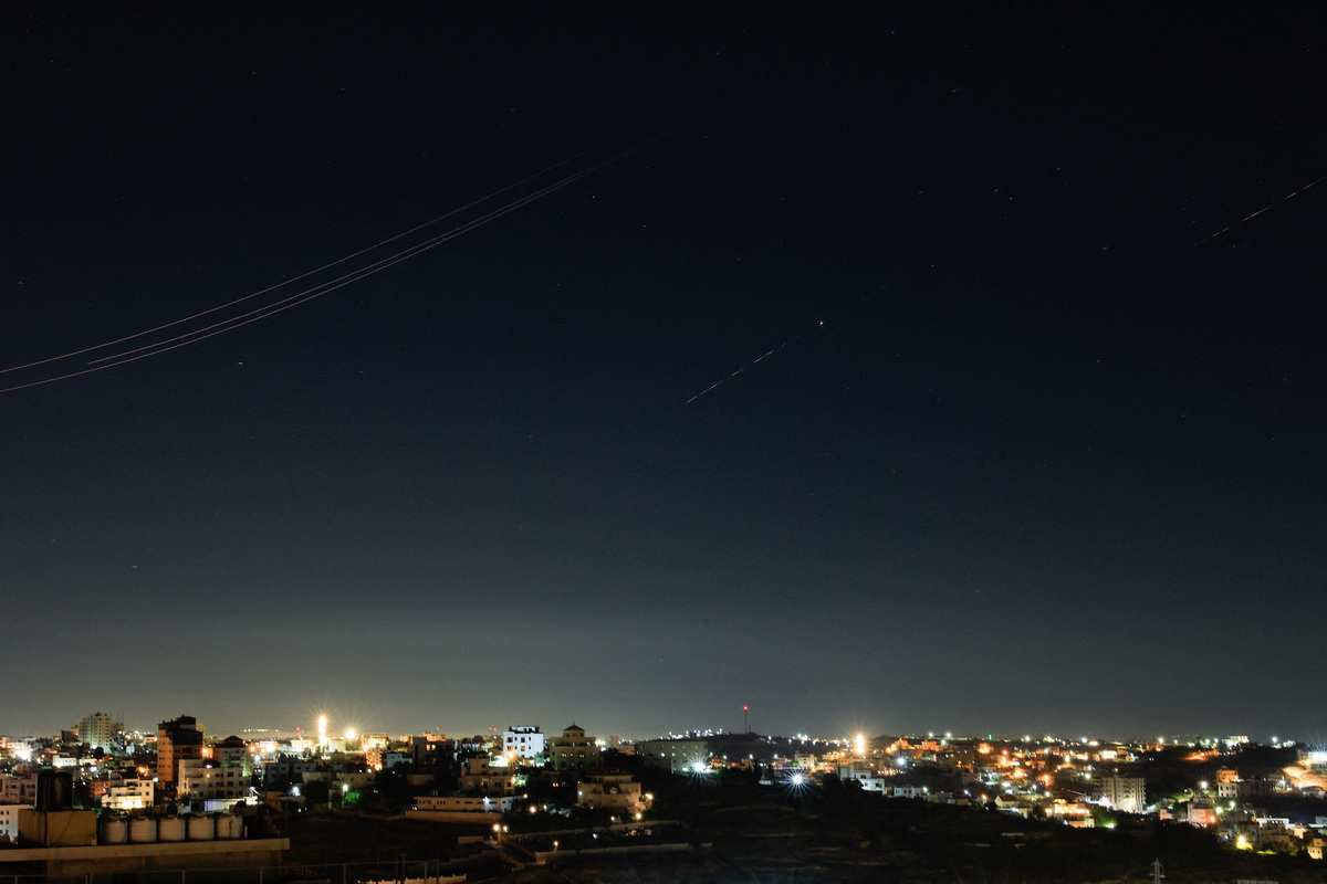 Iranian missiles fly in the sky over Israel, as seen from Hebron, in the Israeli-occupied West Bank, June 7, 2026. REUTERS/Mussa Qawasma