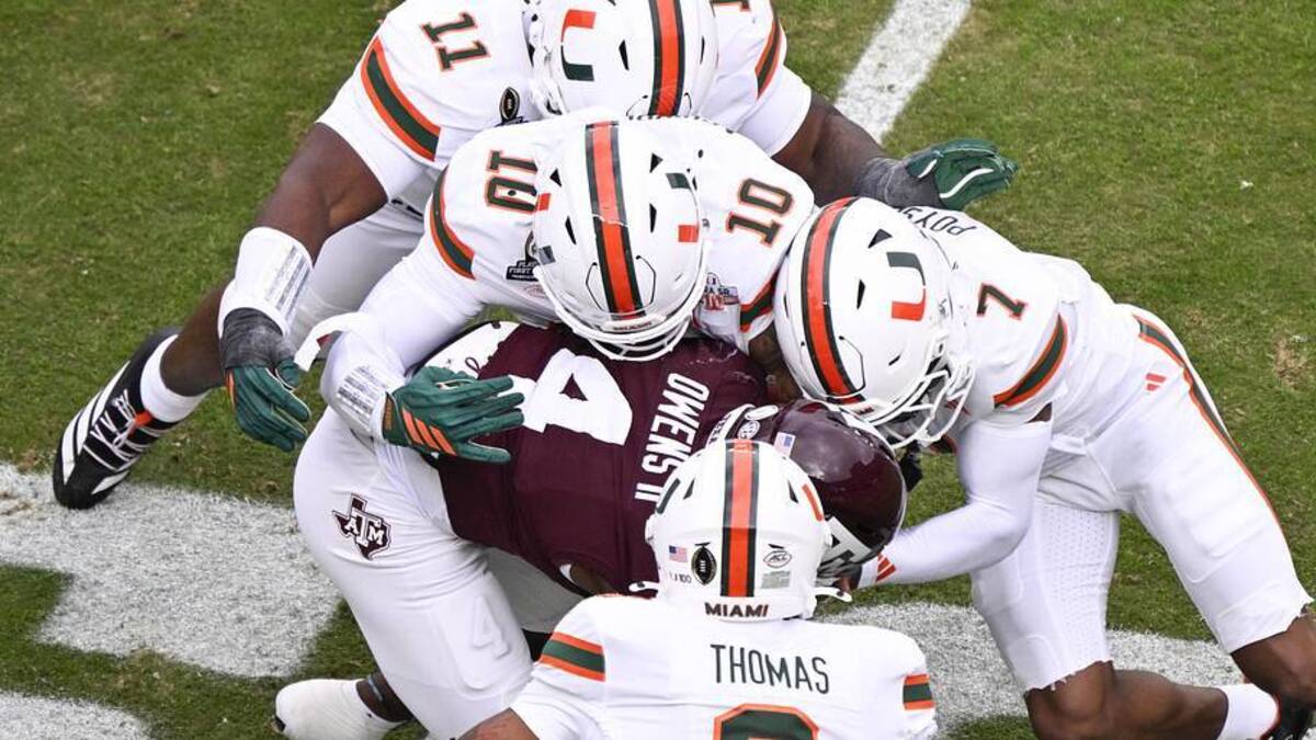  Dec 20, 2025; College Station, TX, USA; Texas A&M Aggies running back Rueben Owens II (4) is tackled by Miami Hurricanes defensive lineman David Blay (11), linebacker Jr. Raul Aguirre (10), safety Zechariah Poyser (7), and defensive back Jakobe Thomas (8) during first quarter of the first round game of the CFP National Playoff at Kyle Field. Mandatory Credit: Jerome Miron-Imagn Images | Jerome Miron-Imagn Images 