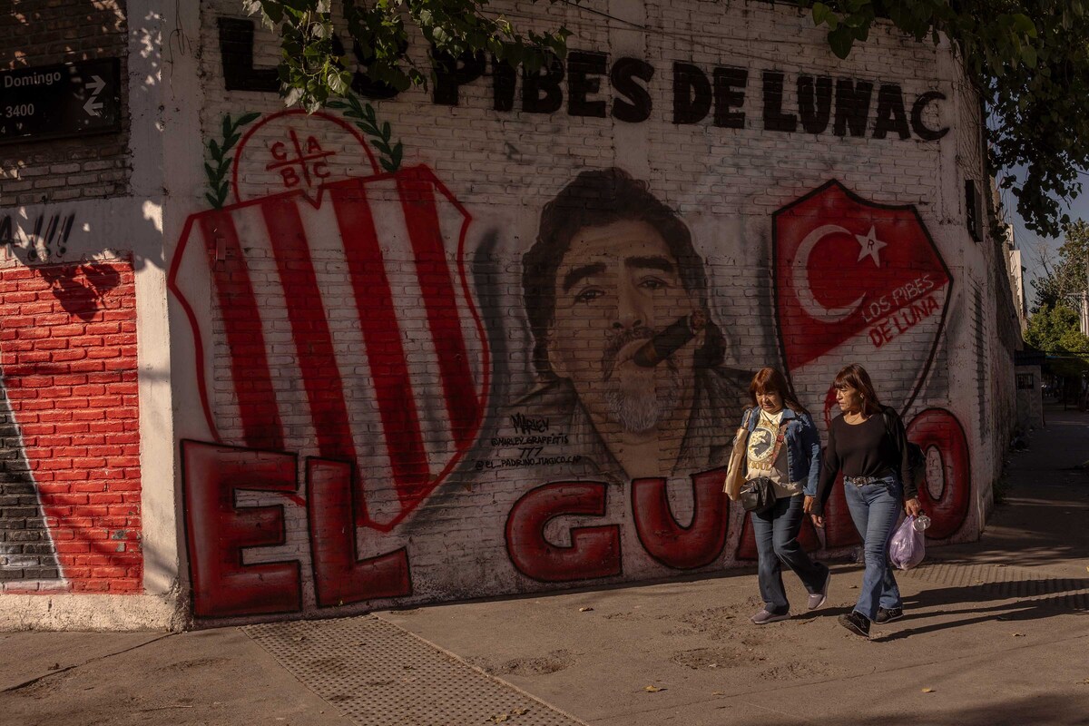 Pedestrians walk by a Maradona mural in Buenos Aires, Argentina, April 24, 2026. A multimillion-dollar battle for a soccer god's brand is being waged across continents, burning investors and tearing his family apart. (Sarah Pabst/The New York Times)