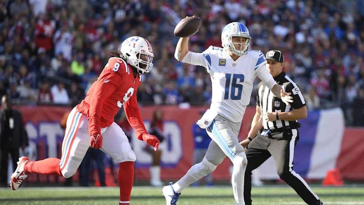  Oct 9, 2022; Foxborough, Massachusetts, USA; Detroit Lions quarterback Jared Goff (16) throws the ball away after being chased by New England Patriots linebacker Matthew Judon (9) during the second half at Gillette Stadium. Mandatory Credit: Bob DeChiara-Imagn Images | Bob DeChiara-Imagn Images 