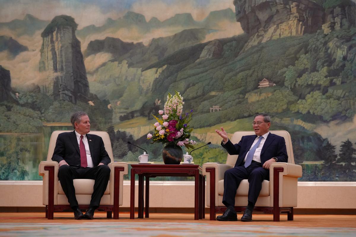 Chinese Premier Li Qiang, talks to U.S. Senator Steve Daines during a meeting at the Great Hall of the People, in Beijing, Thursday, May 7, 2026.     Andy Wong/Pool via REUTERS