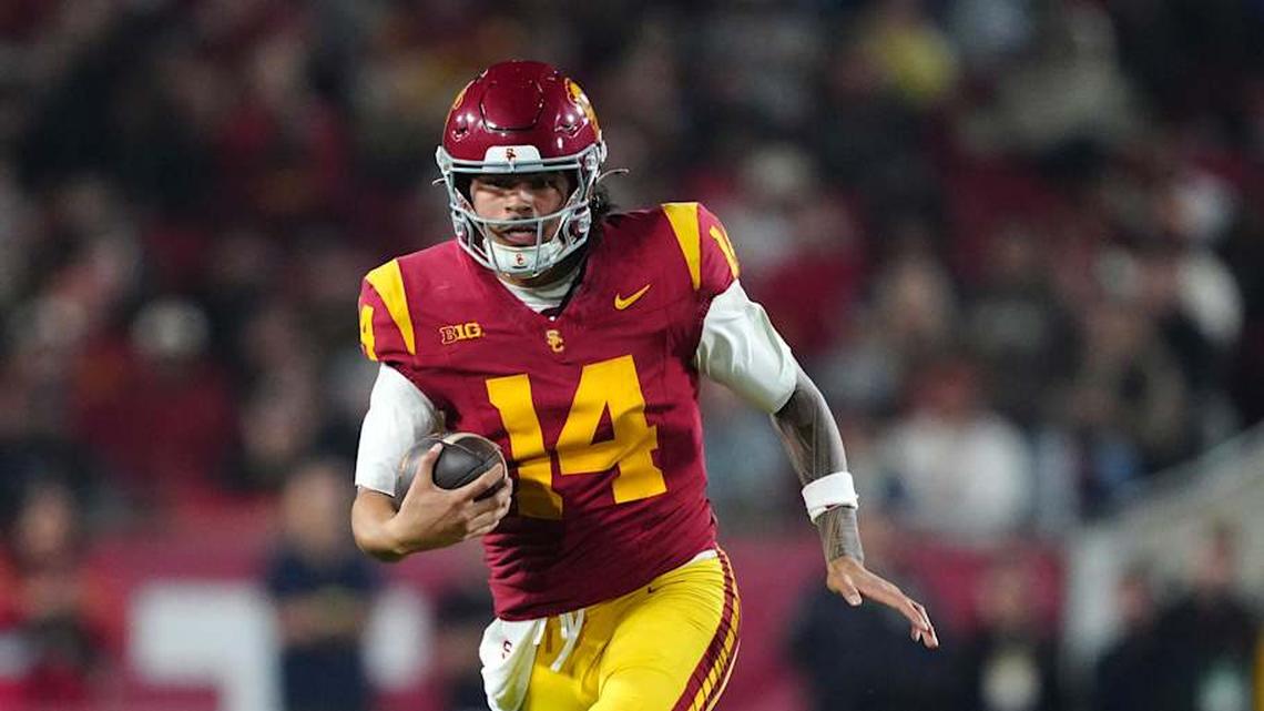  Nov 29, 2025; Los Angeles, California, USA; Southern California Trojans quarterback Jayden Maiava (14) carries the ball against the UCLA Bruins in the first half at United Airlines Field at Los Angeles Memorial Coliseum. Mandatory Credit: Kirby Lee-Imagn Images | Kirby Lee-Imagn Images 