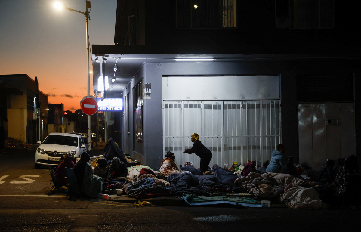 Foreign nationals sleep on the street after fleeing their homes amid anti-immigrant protests in Durban, South Africa, June 9, 2026. REUTERS/Rogan Ward