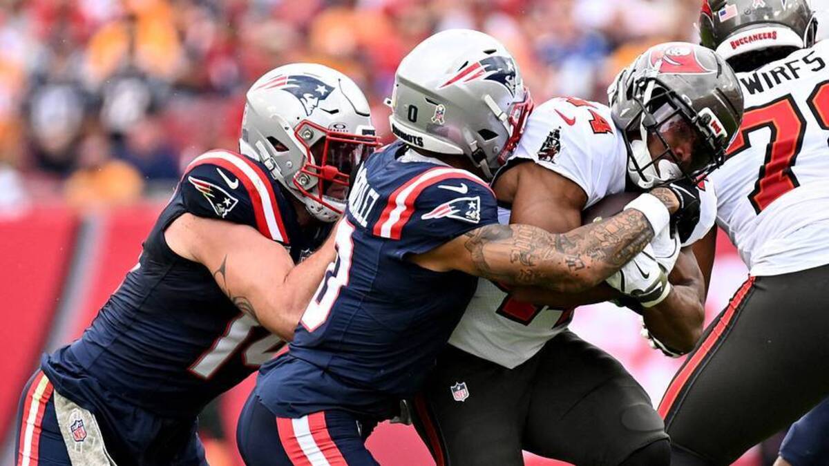  Nov 9, 2025; Tampa, Florida, USA; Tampa Bay Buccaneers running back Sean Tucker (44) is tackled by New England Patriots cornerback Christian Gonzalez (0) and New England Patriots linebacker Robert Spillane (14) during the first quarter at Raymond James Stadium. Mandatory Credit: Jonathan Dyer-Imagn Images | IMAGN IMAGES via Reuters Connect 