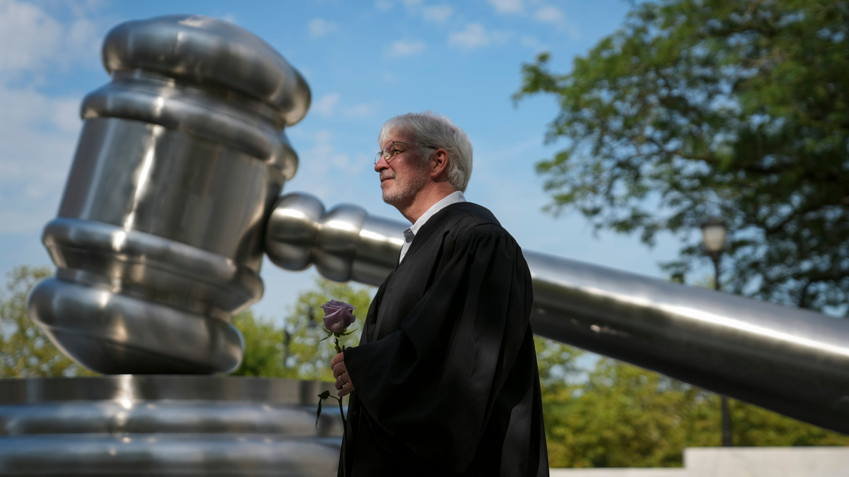 As part of the Justice In Motion bus tour from Pennsylvania to Michigan, former Ohio Supreme Court Justice Michael Donnelly gathers with fellow judges outside the Ohio Supreme Court building during a stop in Columbus, Ohio on July 8, 2026. The civic engagement tour is promoting a constitutional government to ensure equal justice under the law and public trust in the judicial system.