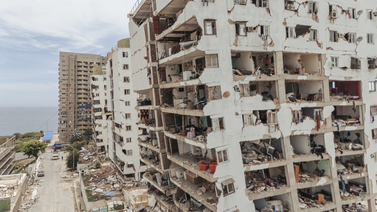 Partially collapsed residential buildings in the Luisa Cáceres de Arismendi Complex public housing project in Catia La Mar, Venezuela, June 30, 2026. After devastating twin earthquakes flattened entire residential neighborhoods last week, experts fear the official death toll of 1,719 could be a serious undercount. (Adriana Loureiro Fernandez/The New York Times)