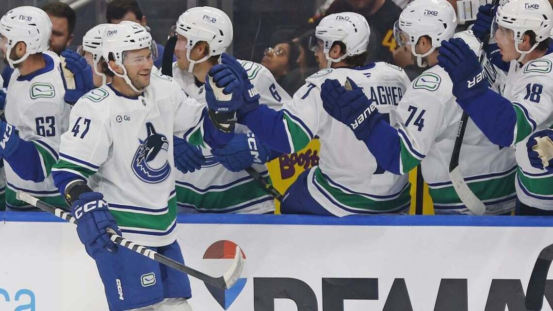 Canucks blow late lead, pull out opening win over Oilers in overtime 
