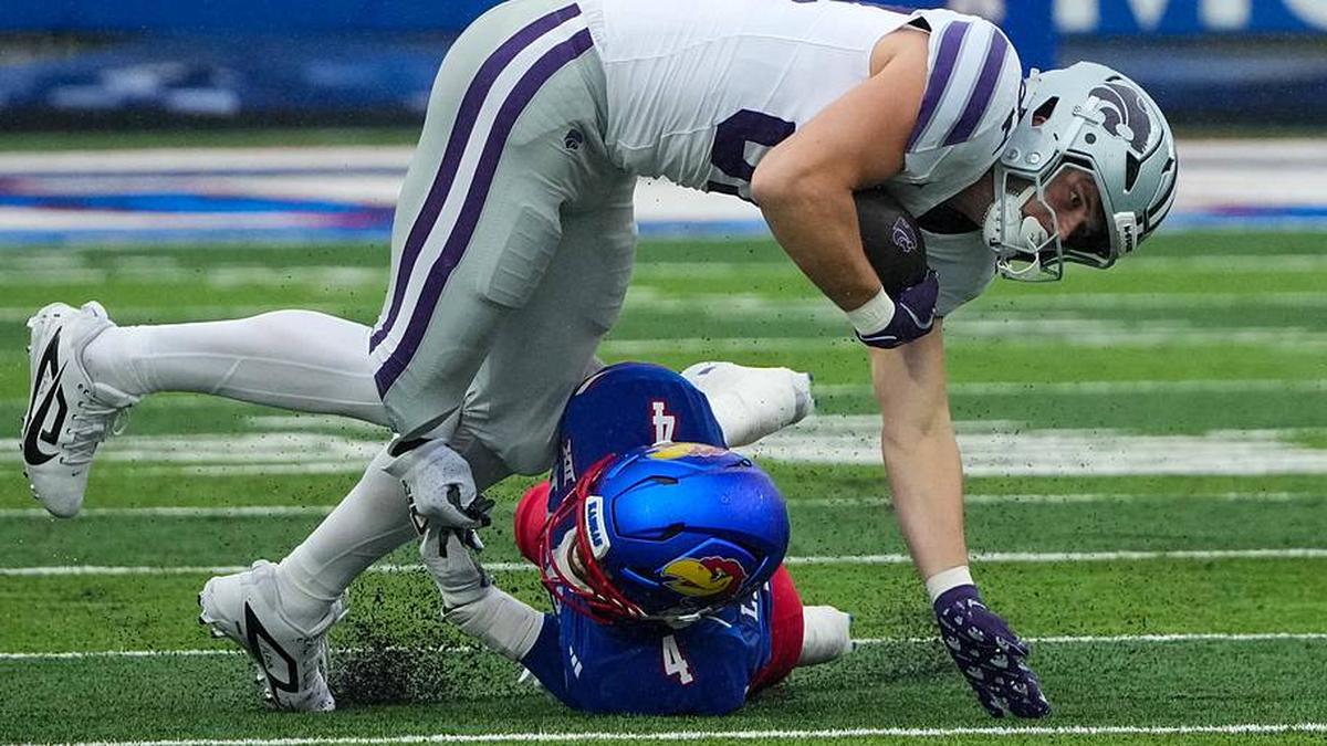  Oct 25, 2025; Lawrence, Kansas, USA; Kansas State Wildcats tight end Brayden Loftin (87) runs the ball as Kansas Jayhawks linebacker Trey Lathan (4) makes the tackle during the first half of the game at David Booth Kansas Memorial Stadium. Mandatory Credit: Denny Medley-Imagn Images | Denny Medley-Imagn Images 