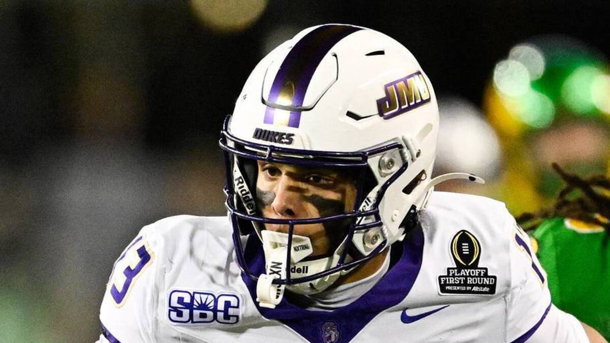  Dec 20, 2025; Eugene, OR, USA; James Madison Dukes wide receiver Landon Ellis (13) runs after making a catch as Oregon Ducks defensive back Theran Johnson (5) defends during the second quarter at Autzen Stadium. Mandatory Credit: Troy Wayrynen-Imagn Images | Troy Wayrynen-Imagn Images 