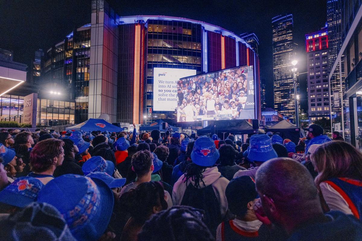 New York Knicks fans attend a watch party for Game 2 of the NBA Eastern Conference Finals outside Madison Square Garden in New York, May 21, 2026. The events have been attended by thousands, and are mostly full of young fans and families, but recently, police have made some arrests because of violence. (José A. Alvarado Jr./The New York Times)