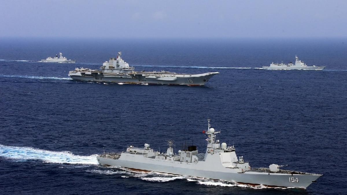 FILE PHOTO: China's aircraft carrier Liaoning (C) takes part in a military drill of Chinese People's Liberation Army (PLA) Navy in the western Pacific Ocean, April 18, 2018. REUTERS/Stringer/File Photo