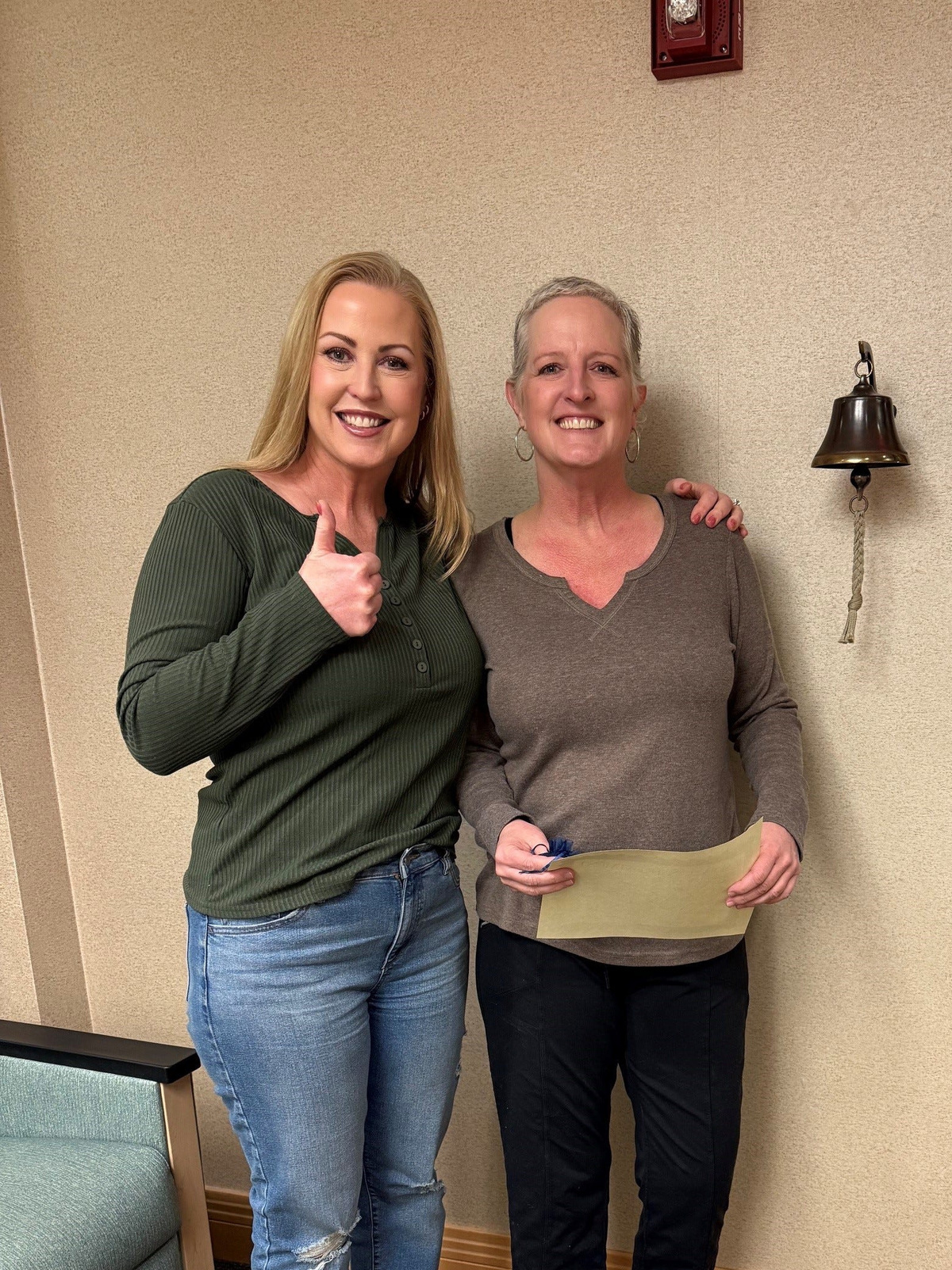 Megan Brownell (left) and her sister, Tracey Kennedy, after Kennedy finished her breast cancer treatment in 2025.