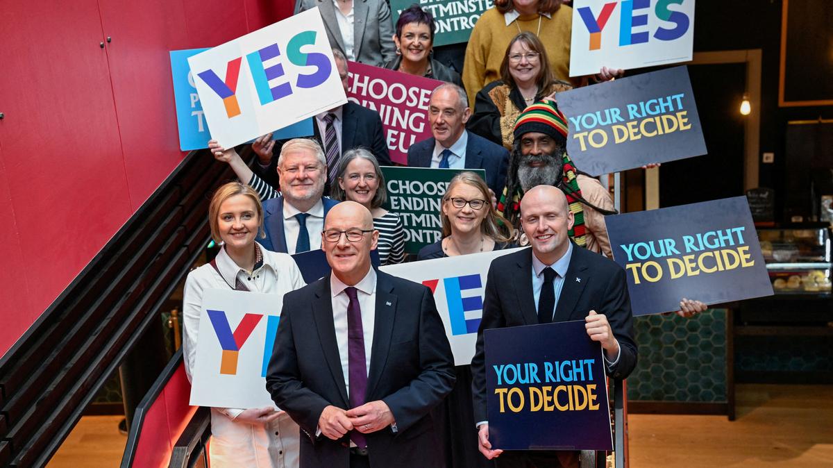 FILE PHOTO: Scottish First Minister and SNP leader John Swinney poses with candidates after giving a speech at the launch of the party's campaign ahead of the 2026 Scottish Parliament election due to be held on May 7, in Glasgow, Scotland, Britain, March 26, 2026. REUTERS/Lesley Martin/File Photo