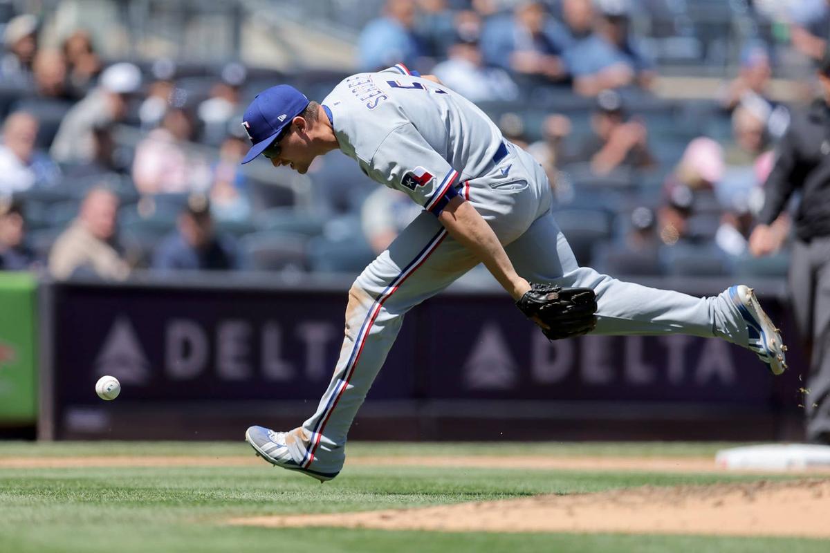  May 7, 2026; Bronx, New York, USA; Texas Rangers shortstop Corey Seager (5) fails to catch an infield pop fly by New York Yankees center fielder Trent Grisham (not pictured) during the fourth inning at Yankee Stadium. Mandatory Credit: Brad Penner-Imagn Images