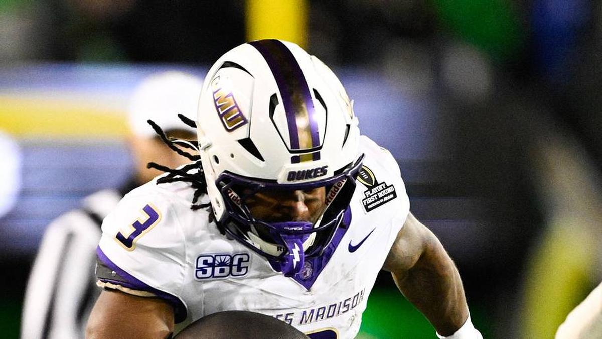  Dec 20, 2025; Eugene, OR, USA; James Madison Dukes running back Wayne Knight (3) rushes as Oregon Ducks defensive back Aaron Flowers (21) defends during the second quarter at Autzen Stadium. Mandatory Credit: Troy Wayrynen-Imagn Images | Troy Wayrynen-Imagn Images 