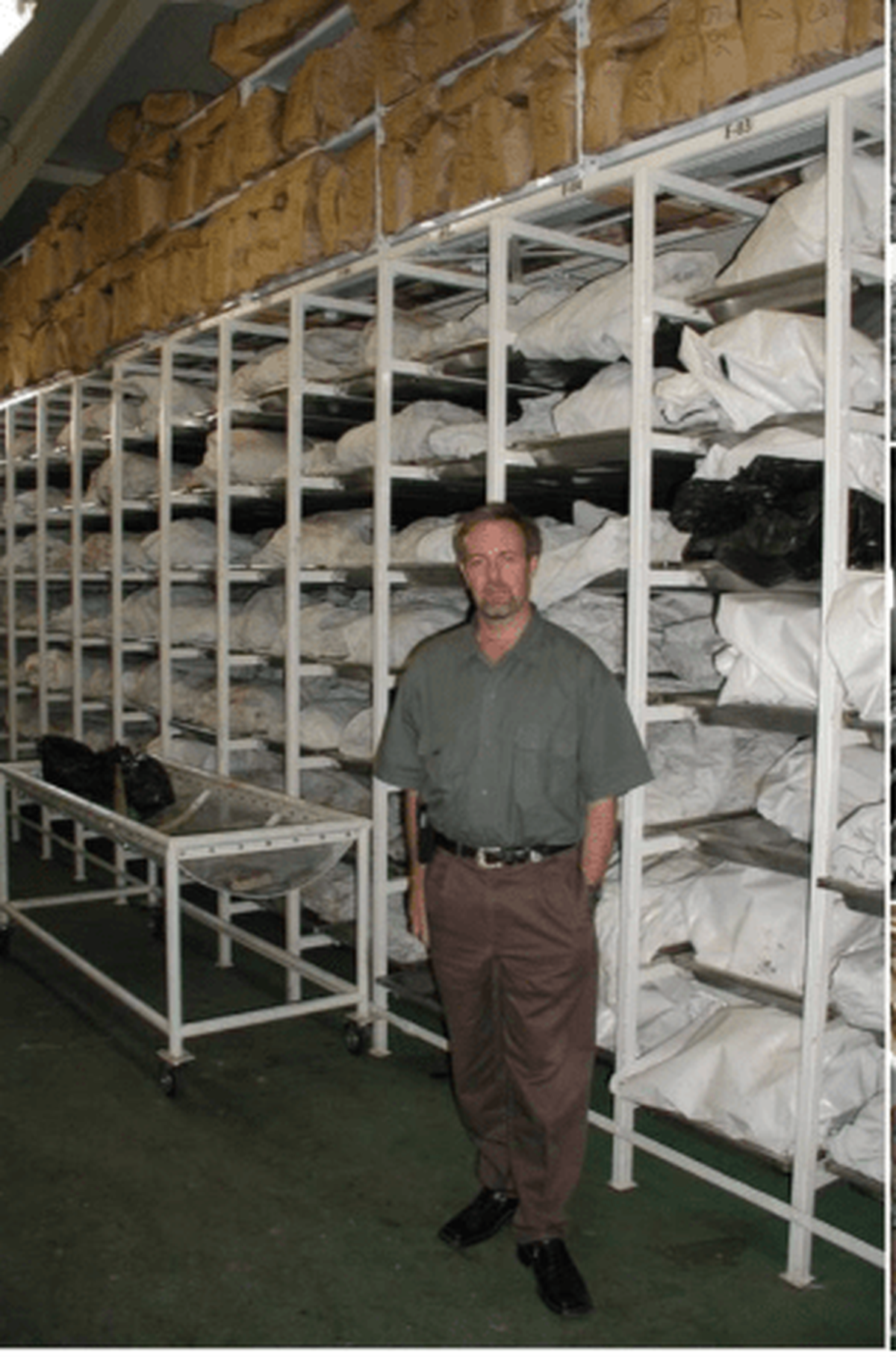  Edwin Huffine stands beside body bags in a mortuary in the city of Tuzla in Bosnia-Herzegovina, where nuclear DNA testing helped identify Bosnian Muslims killed by Serbian forces during the 1990s war. (Photo courtesy of Edwin Huffine) 