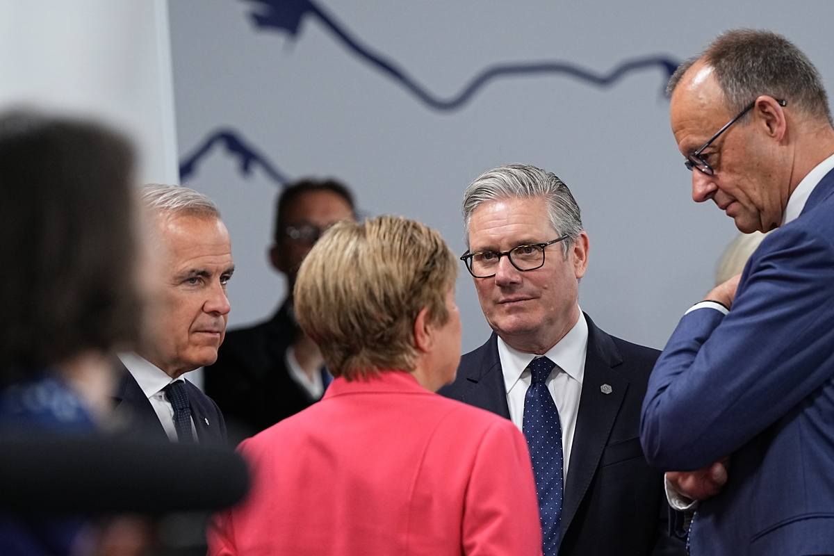 Prime Minister Keir Starmer of Britain, Prime Minister Mark Carney of Canada, left, and Chancellor Friedrich Merz of Germany, right, speak with Kristalina Georgieva, managing director of the International Monetary Fund, at the G7 Summit in Evian-les-Bains, France, on Wednesday, June 17, 2026. (Haiyun Jiang/The New York Times)