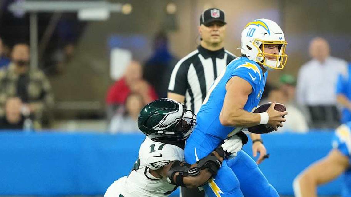  Dec 8, 2025; Inglewood, California, USA; Philadelphia Eagles linebacker Nakobe Dean (17) tackles Los Angeles Chargers quarterback Justin Herbert (10) in the first half at SoFi Stadium. Mandatory Credit: Kirby Lee-Imagn Images | Kirby Lee-Imagn Images 
