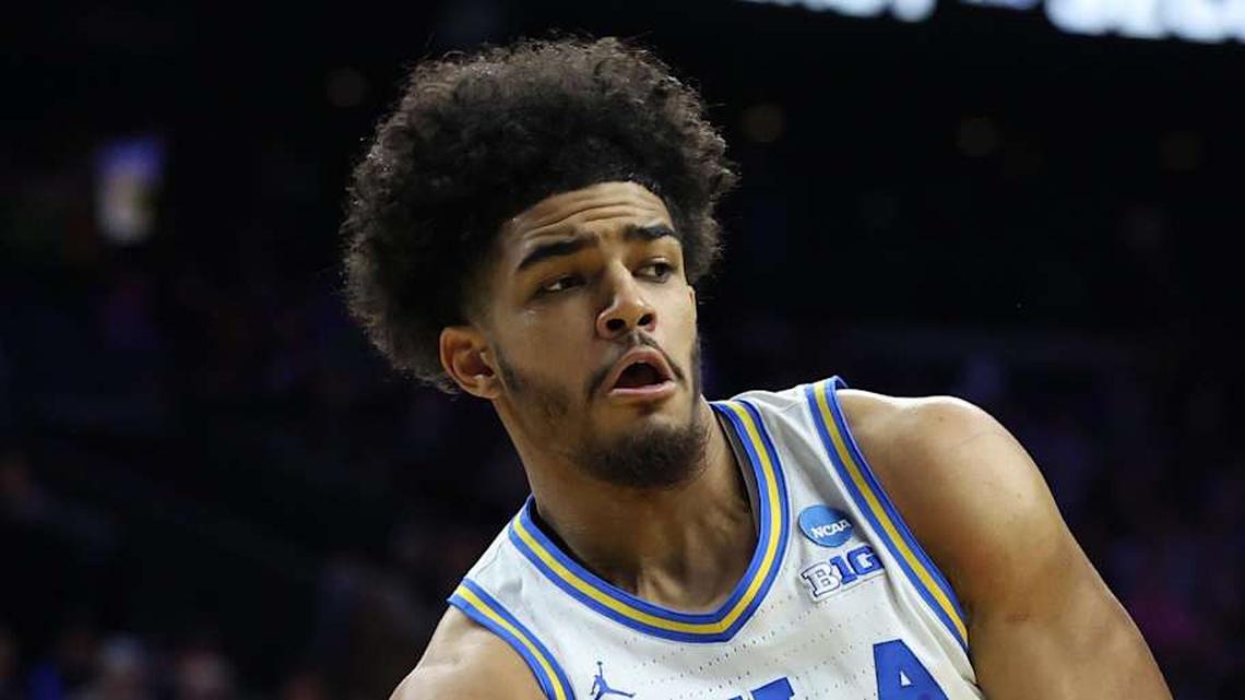  Mar 20, 2026; Philadelphia, PA, USA; UCLA Bruins guard Eric Freeny (8) makes a pass against UCF Knights center John Bol (7) in the second half during a first round game of the men's 2026 NCAA Tournament at Xfinity Mobile Arena. Mandatory Credit: Bill Streicher-Imagn Images | Bill Streicher-Imagn Images 