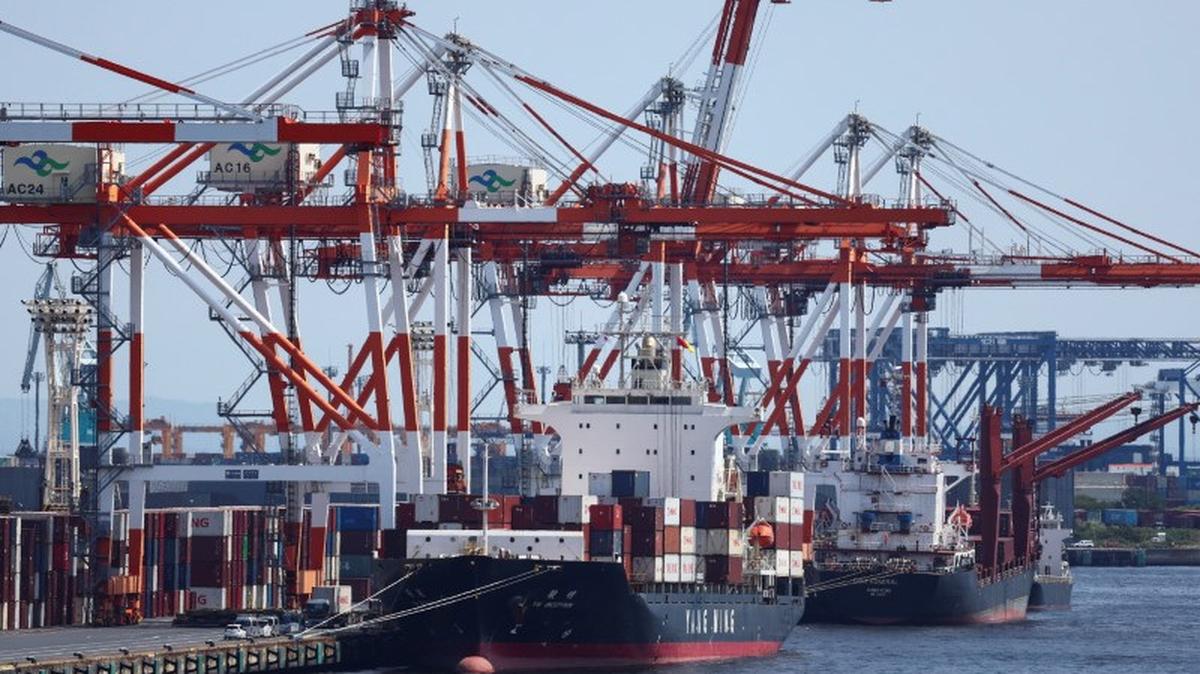 A cargo ship carrying containers is seen at an industrial port within Tokyo Port, Japan August 28, 2025. REUTERS/Issei Kato