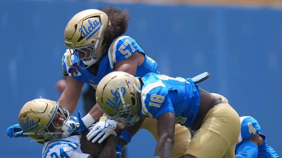  May 2, 2026; Pasadena, CA, USA; UCLA Bruins linebacker Matthew Muasau (57) and defensive backs Osiris Gilbert (18) and Cole Martin (4) tackle receiver Jonah Smith (24) during the spring game at Rose Bowl. Mandatory Credit: Kirby Lee-Imagn Images | Kirby Lee-Imagn Images 