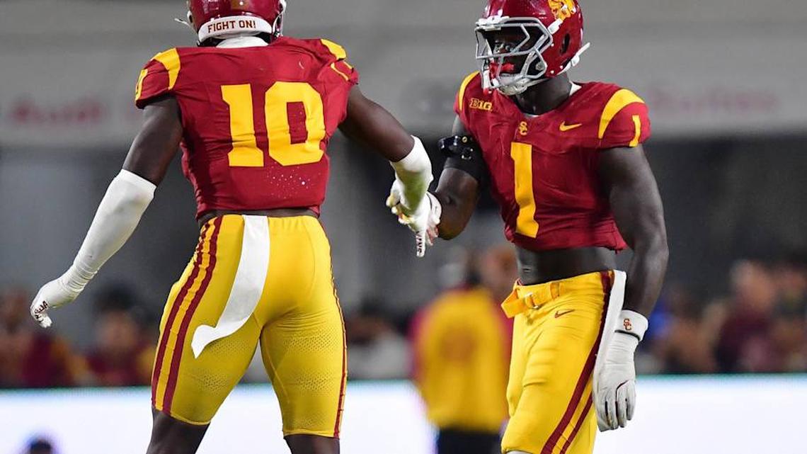  Sep 20, 2025; Los Angeles, California, USA; Southern California Trojans defensive end Braylan Shelby (10) celebrates with defensive end Kameryn Crawford (1) after bringing down Michigan State Spartans quarterback Aidan Chiles (2) during the first half at the Los Angeles Memorial Coliseum. | Gary A. Vasquez-Imagn Images 