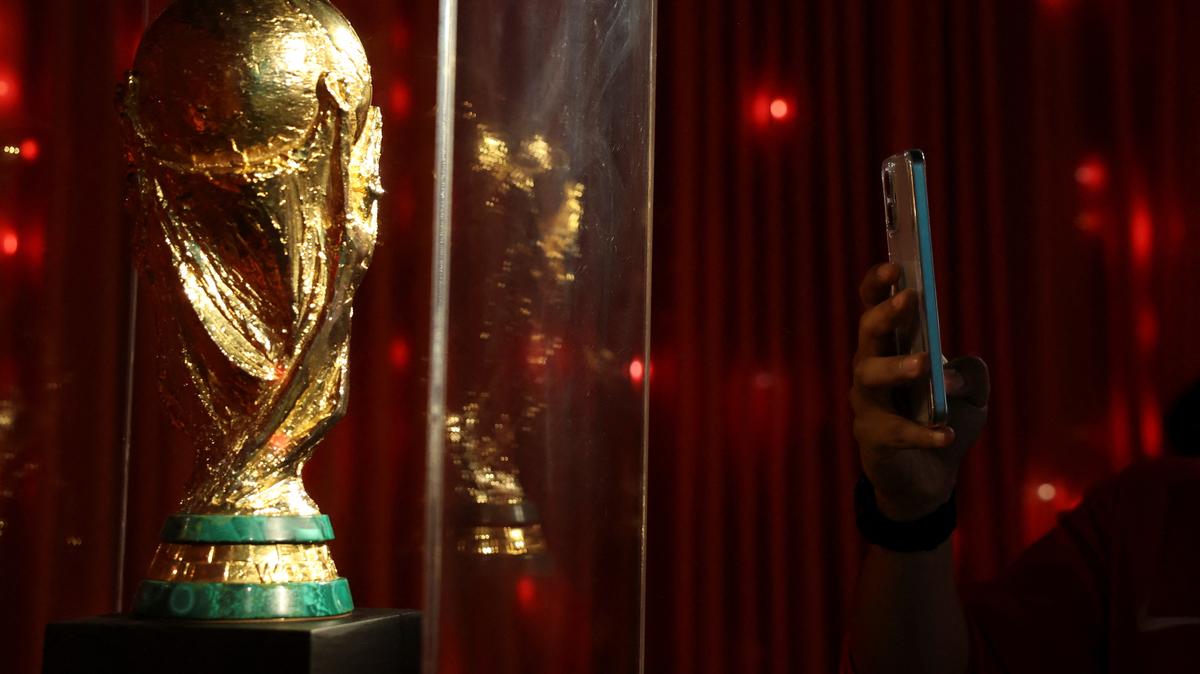 A man takes a photo of a replica of the World Cup trophy as he visits the "Epic Album" exhibition, the biggest football exhibition in Latin America that contains relics of legends such as Ronaldo, Cruyff, Pelé and a collection of Mexican national team t-shirts, as the 2026 FIFA World Cup approaches in Mexico at the Museo Yancuic, in Mexico City, Mexico May 15, 2026. REUTERS/Raquel Cunha