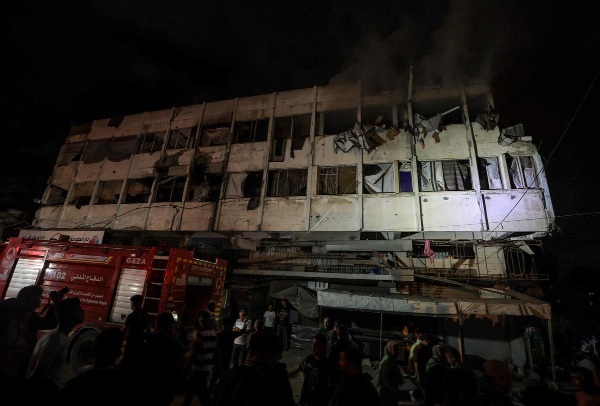 Palestinians gather at the site of an Israeli strike on a residential building in Gaza City, May 27, 2026. REUTERS/Dawoud Abu Alkas
