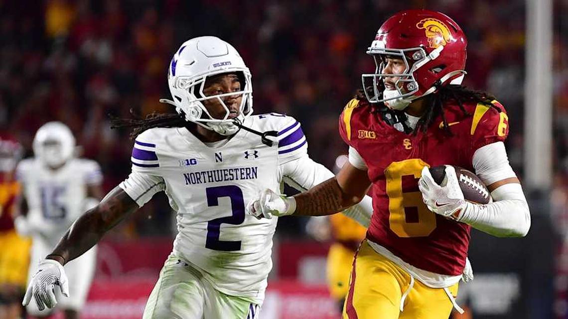  Nov 7, 2025; Los Angeles, California, USA; Southern California Trojans wide receiver Makai Lemon (6) runs the ball against Northwestern Wildcats cornerback Fred Davis II (2) during the second half at the Los Angeles Memorial Coliseum. Mandatory Credit: Gary A. Vasquez-Imagn Images | Gary A. Vasquez-Imagn Images 