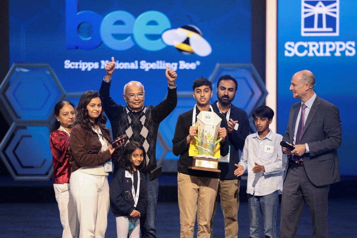 Shrey Parikh holds the trophy as members of his family react, after winning the annual Scripps National Spelling Bee by spelling the word "cashaw", in Washington, D.C., U.S., May 28, 2026. REUTERS/Evelyn Hockstein