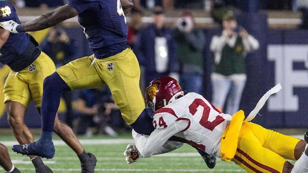  Oct 18, 2025; South Bend, Indiana, USA; Notre Dame Fighting Irish running back Jeremiyah Love (4) runs the ball while Southern California Trojans safety Christian Pierce (24) defends in the first half at Notre Dame Stadium. Mandatory Credit: Trevor Ruszkowski-Imagn Images | Trevor Ruszkowski-Imagn Images 